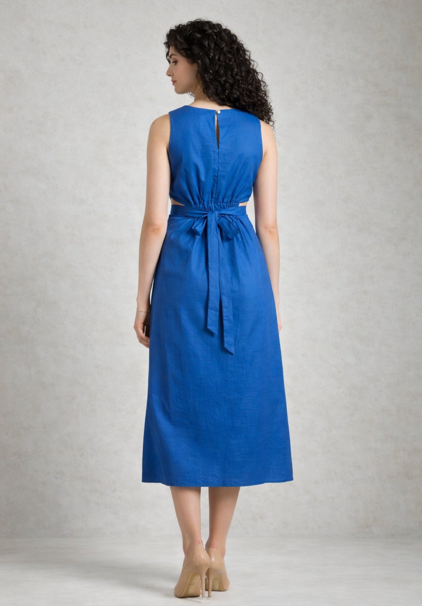Lifestyle shot of blue cotton A-line dress styled with sandals