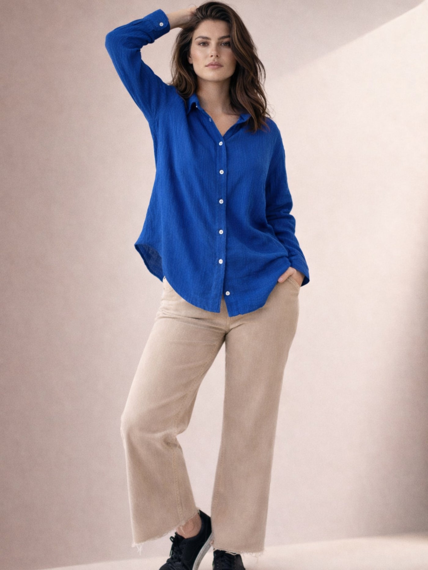 Detail of long sleeve cuff on blue wrinkled cotton shirt