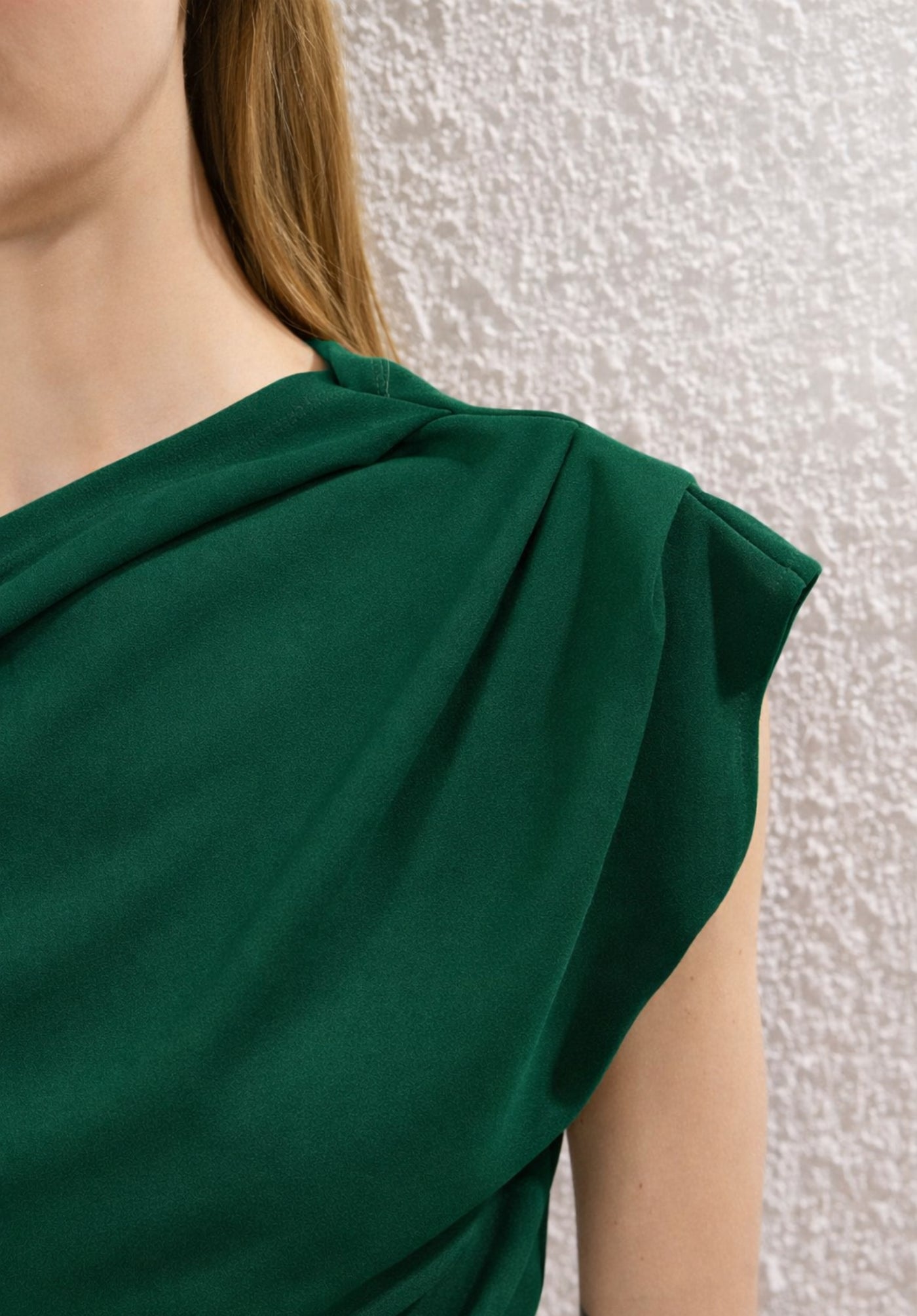 Full-length view of green asymmetric off-shoulder top on model