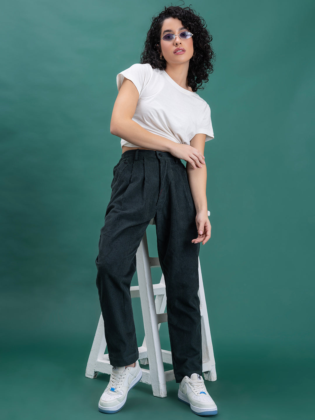 Pocket detail on green corduroy baggy trousers