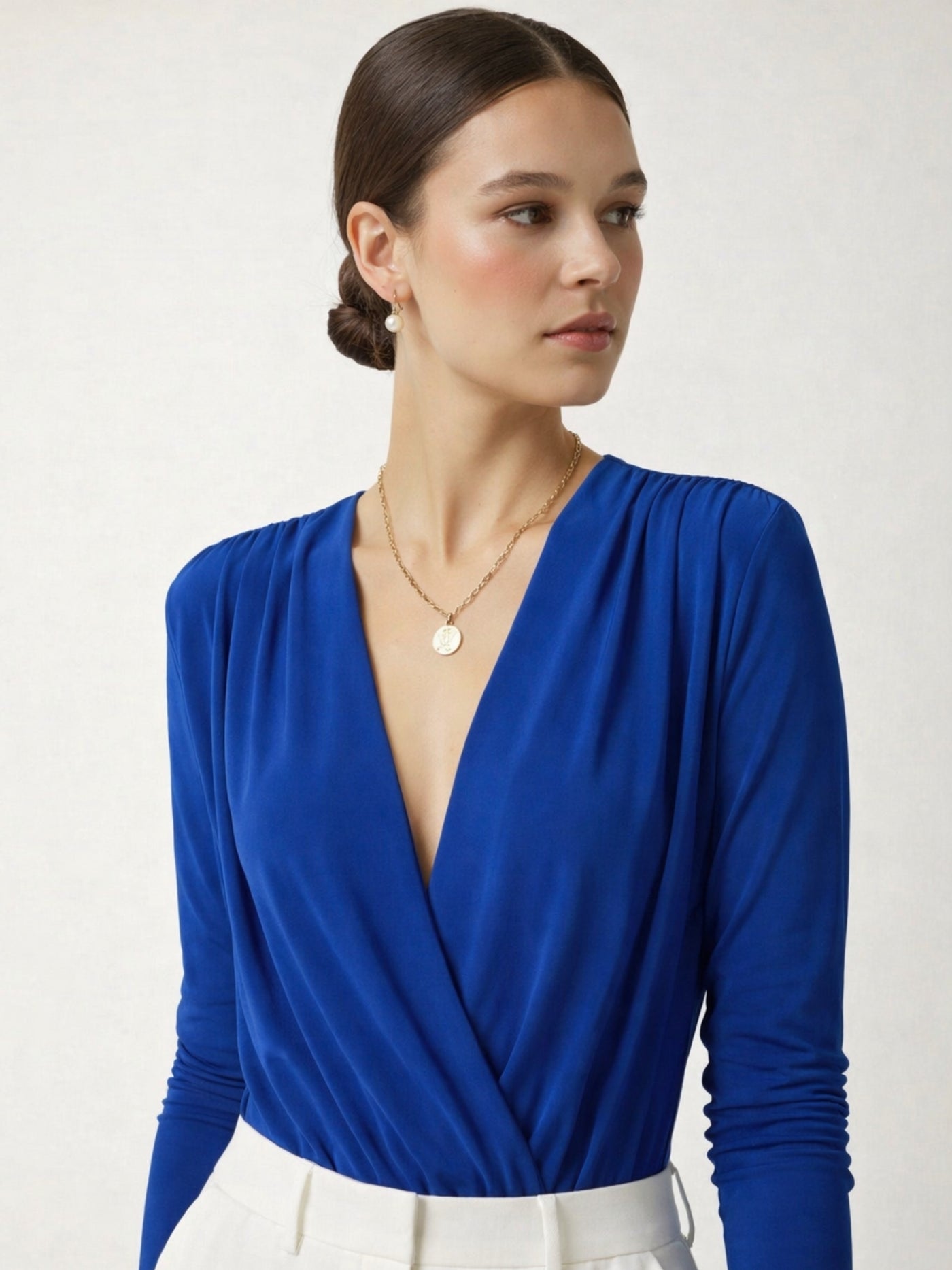 Back view of royal blue long-sleeve bodysuit top