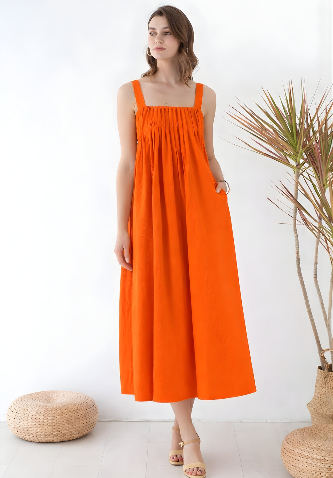 Front view of rust pleated pure cotton A-line smoked waist dress for women