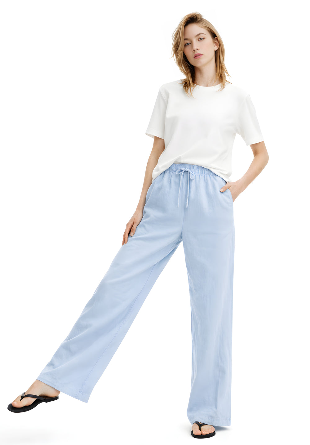 Side view of sky blue baggy trousers showing relaxed straight leg fit