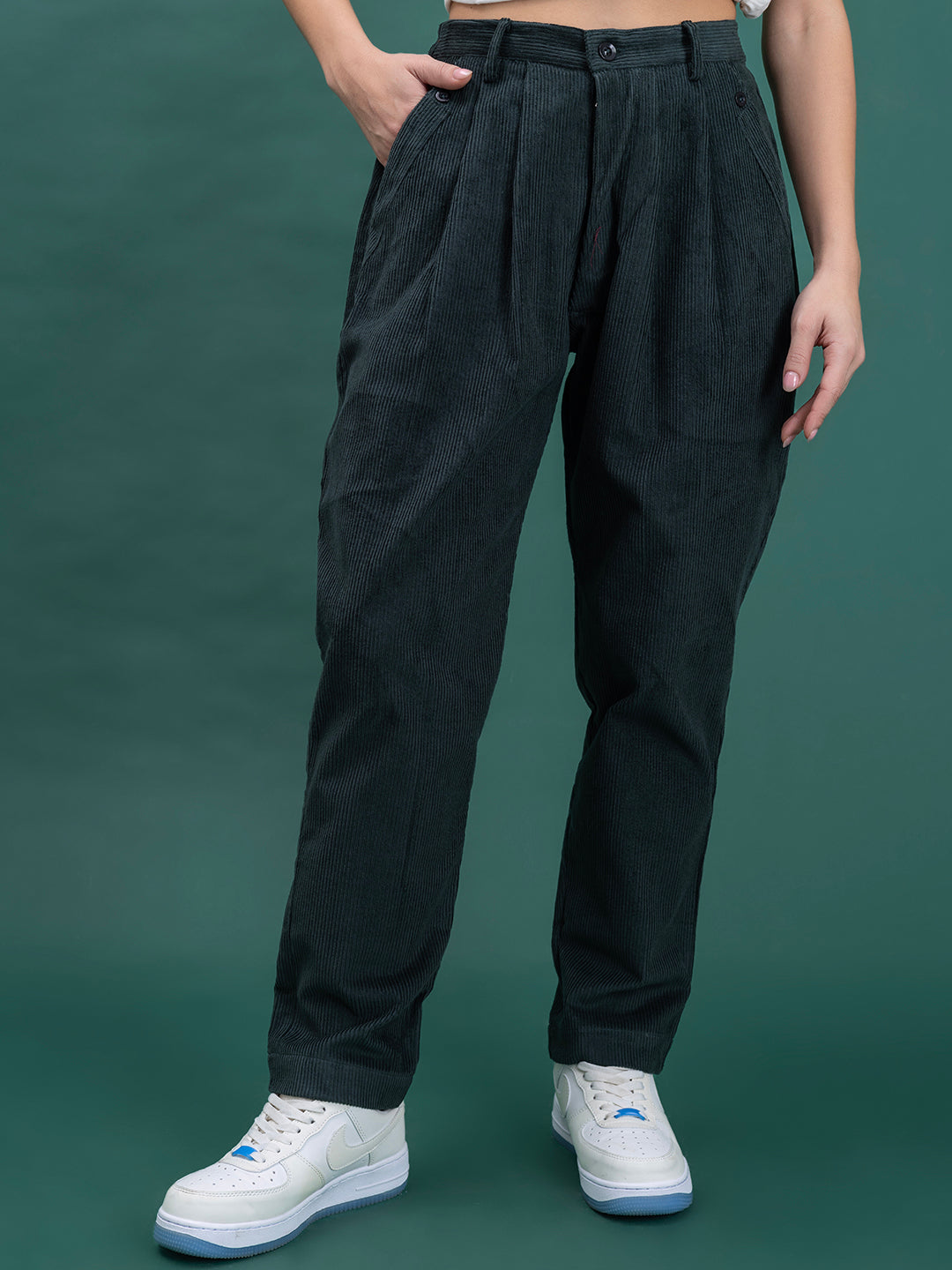 Front view of green corduroy baggy trousers for women with mid-rise fit