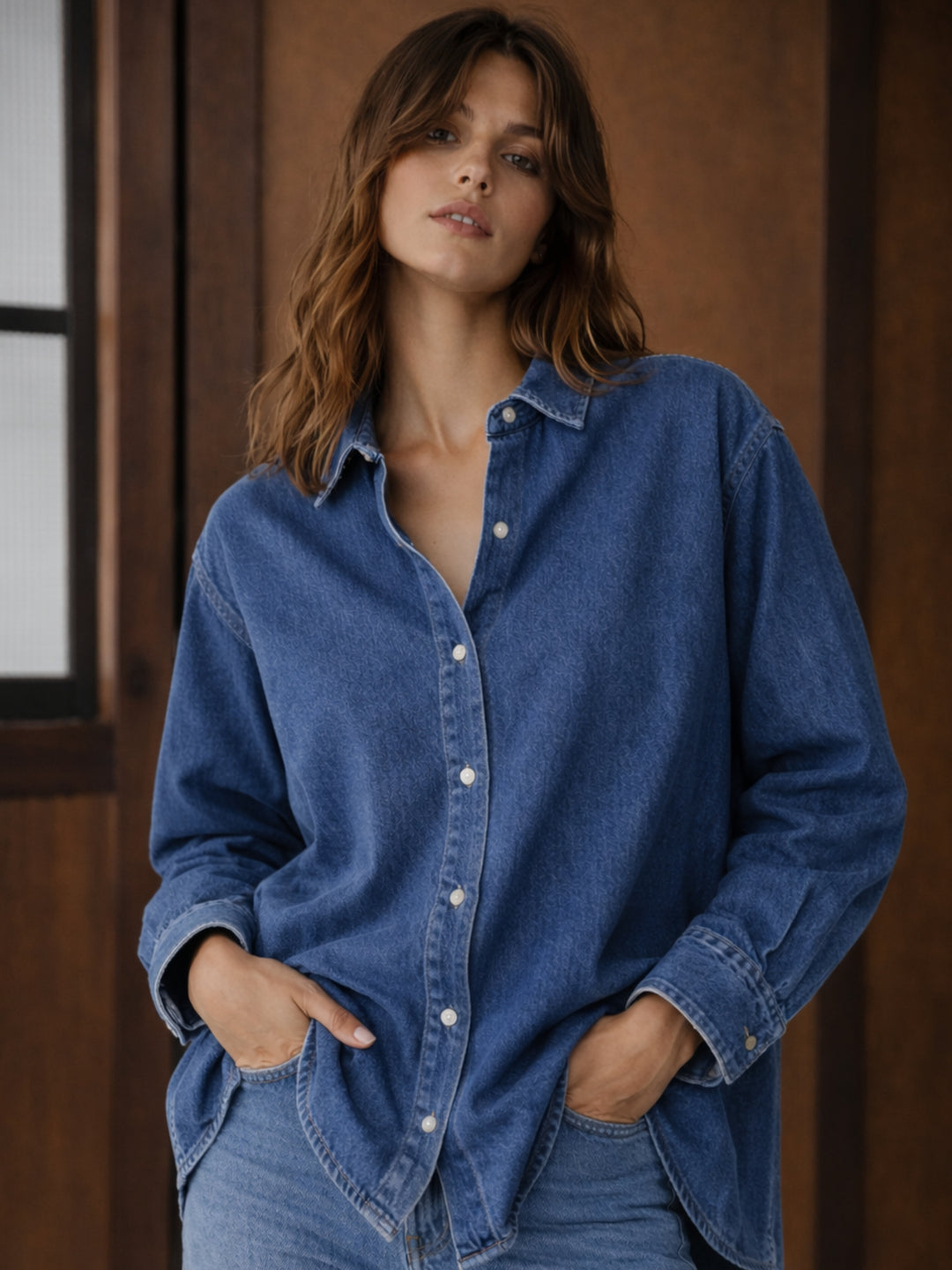 Front view of dark blue oversized denim shirt for women