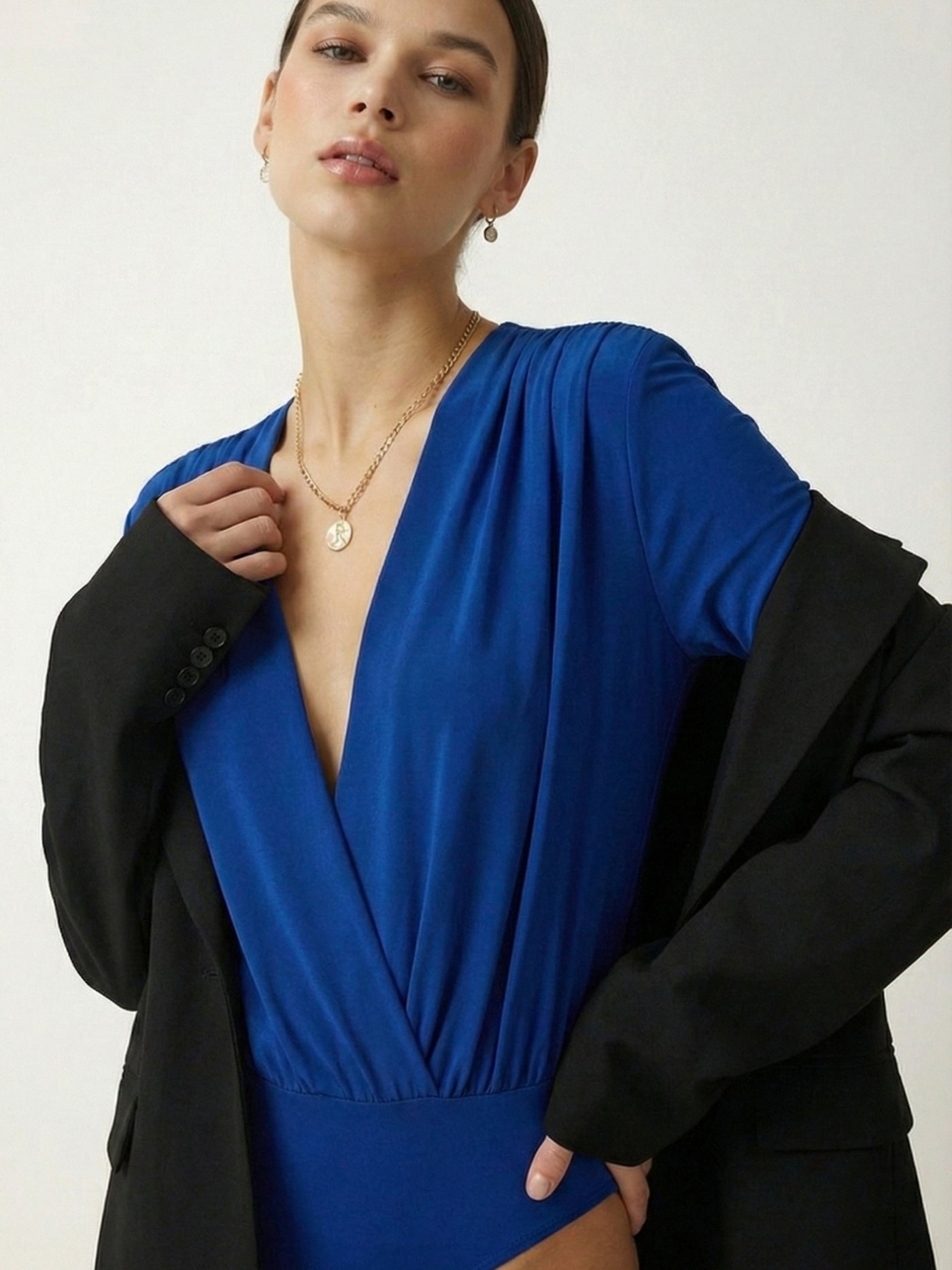 Close-up of V-neckline on royal blue polyester bodysuit top