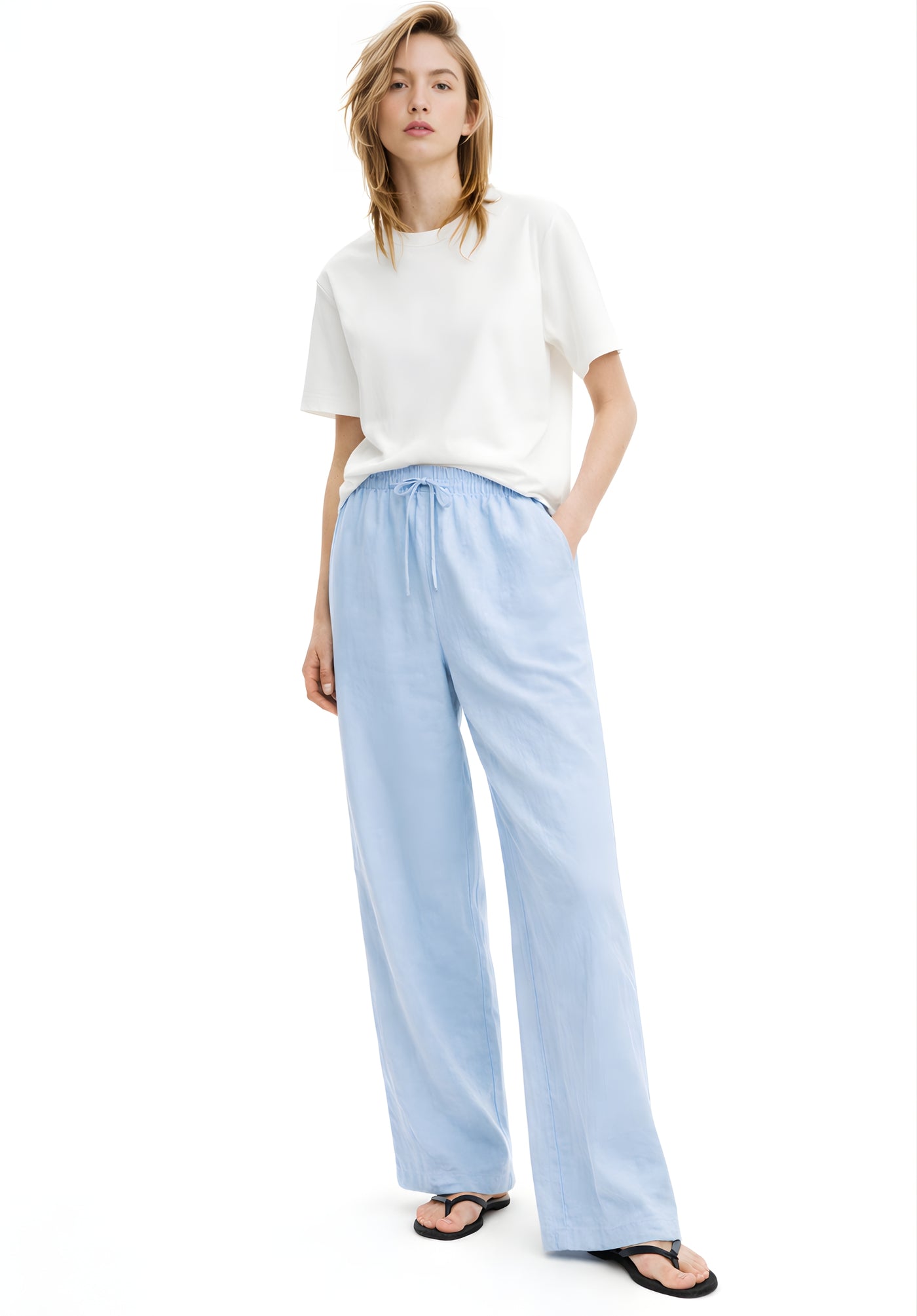 Close-up of mid-rise elasticated drawstring waistband on sky blue trousers