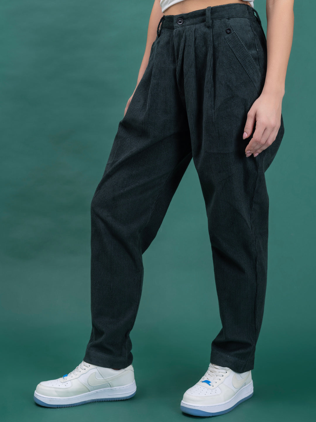 Close-up of corduroy fabric texture on green baggy trousers