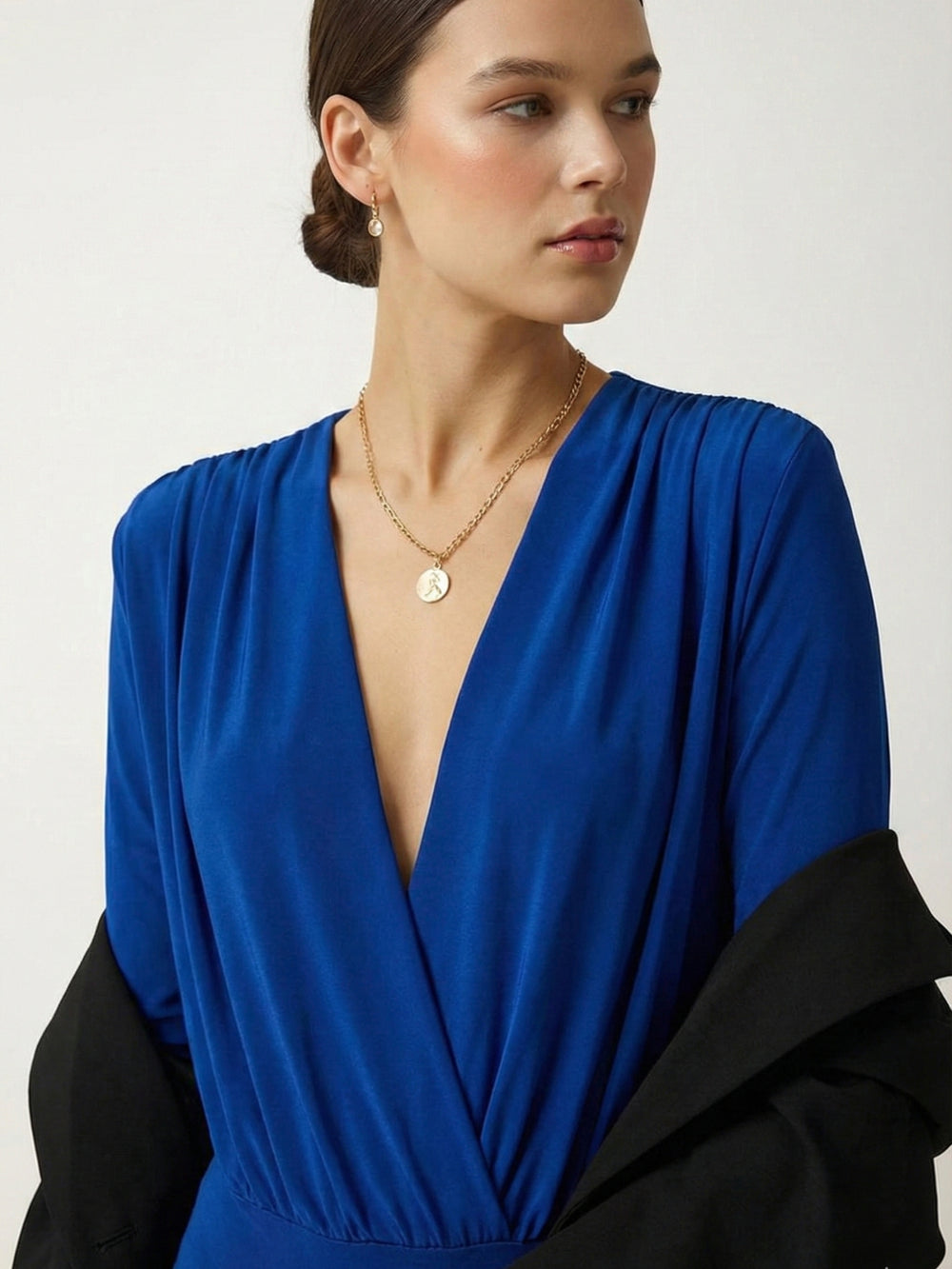Side view of royal blue V-neck long-sleeve bodysuit top