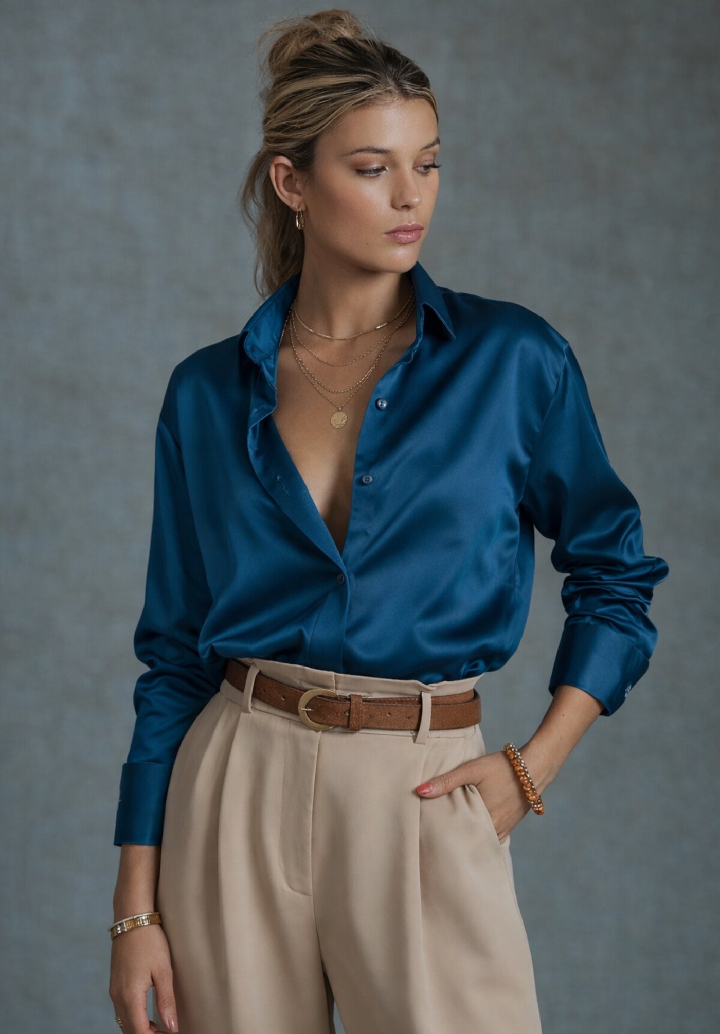 Lifestyle shot of woman in navy satin shirt