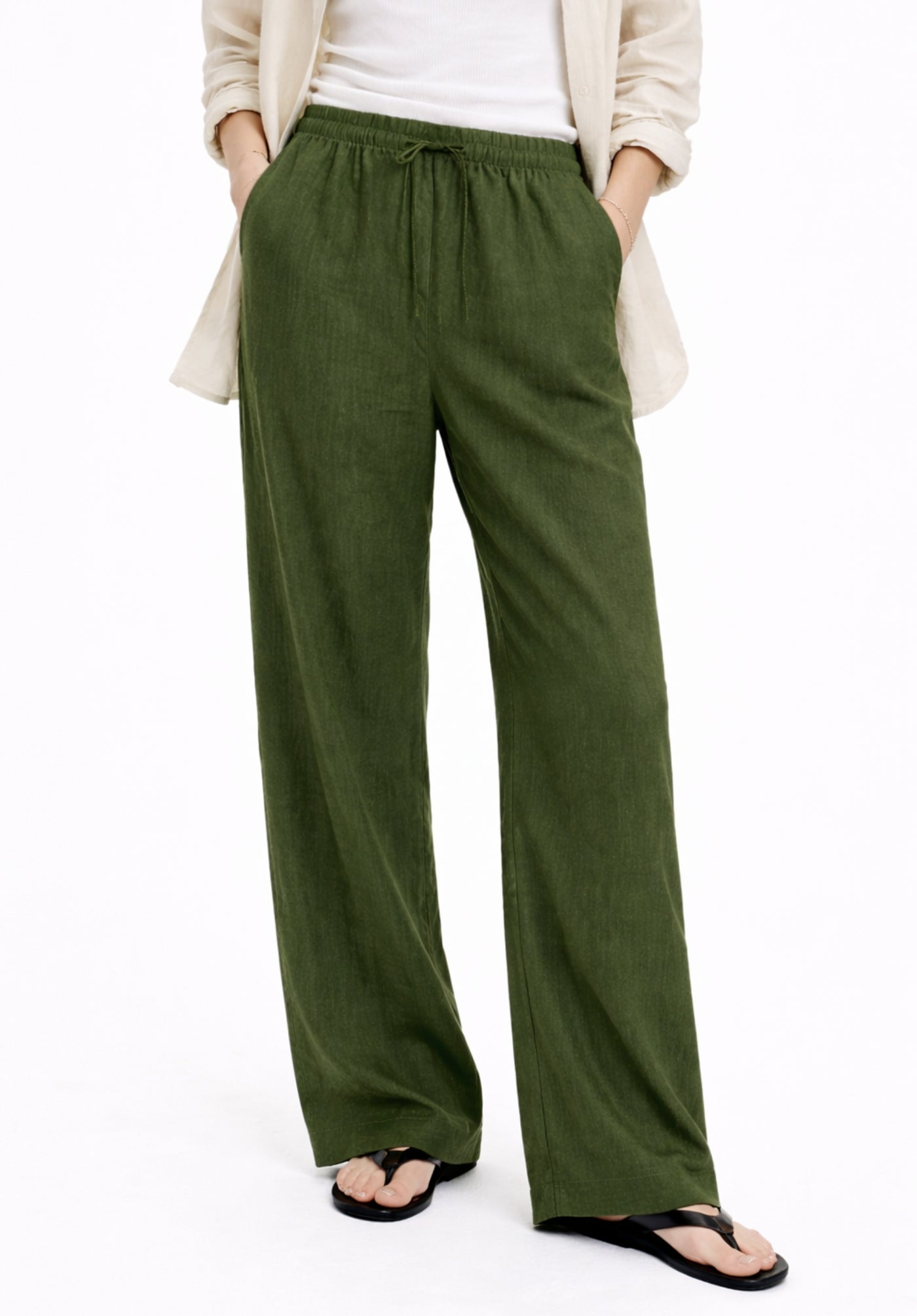 Olive baggy trousers side view showing drawstring waist