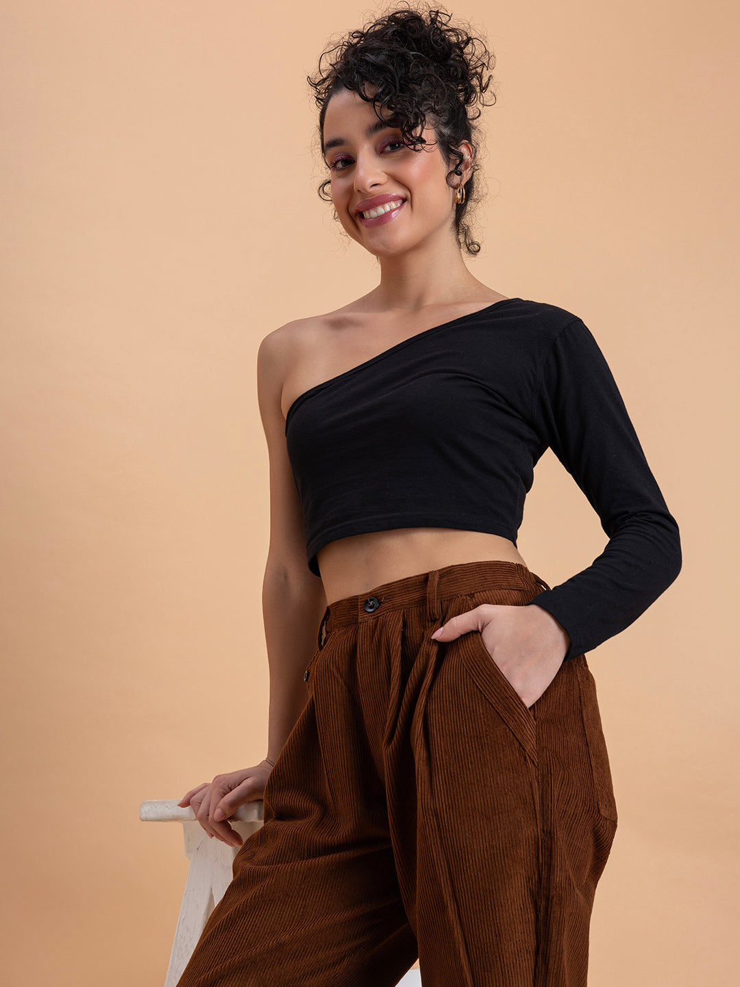 Lifestyle shot of brown corduroy baggy trousers styled casually