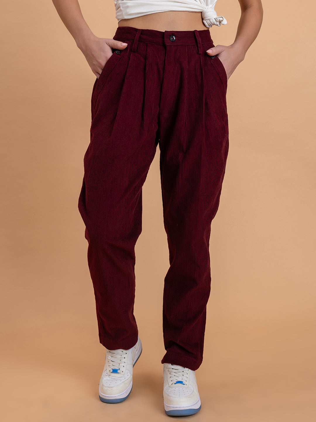 Front view of maroon corduroy baggy trousers for women with mid-rise fit