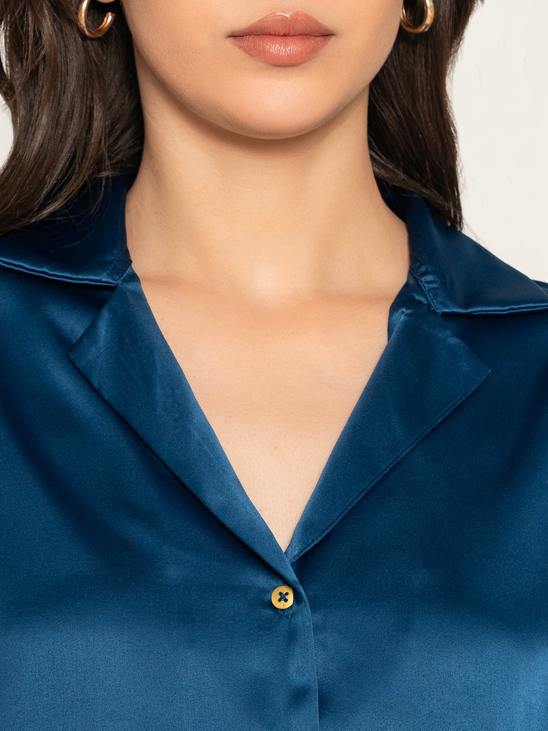 Detail of buttons on navy satin shirt