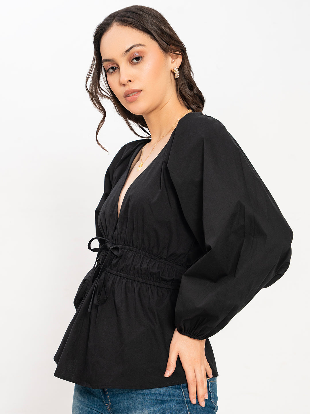 Styling shot of black V-neck top with denim