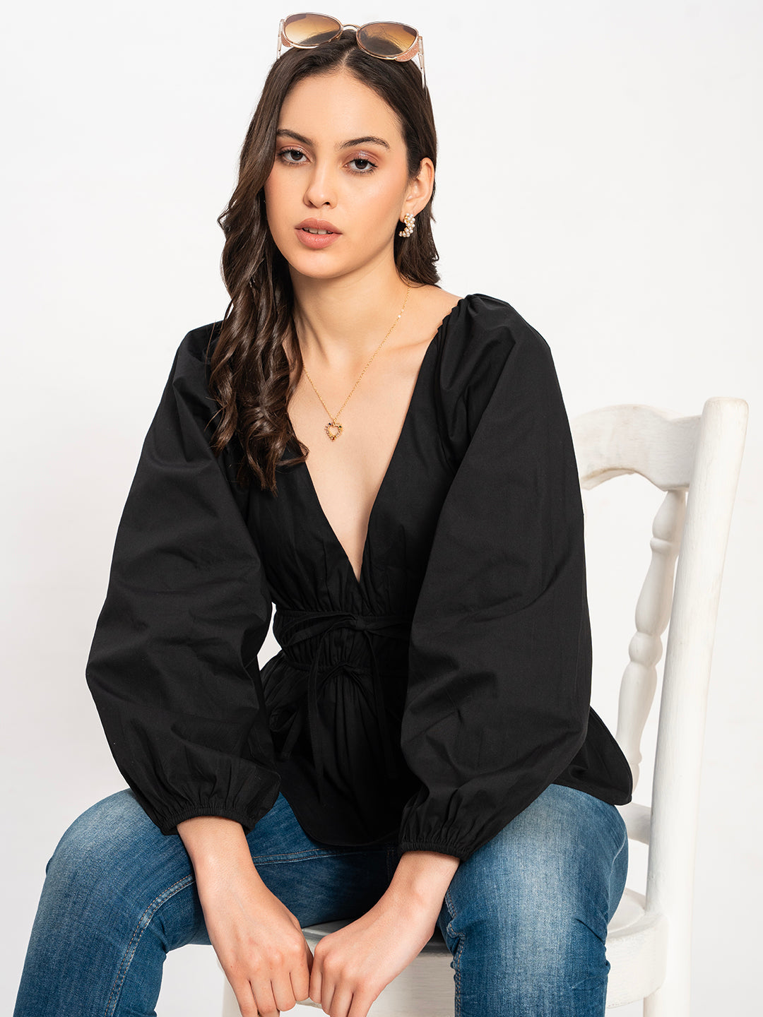 Detail of soft drape on black poplin top