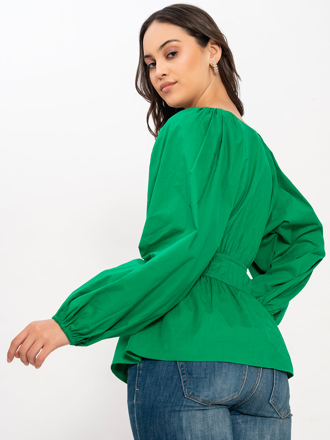 Detail of buttoned cuff on green poplin top