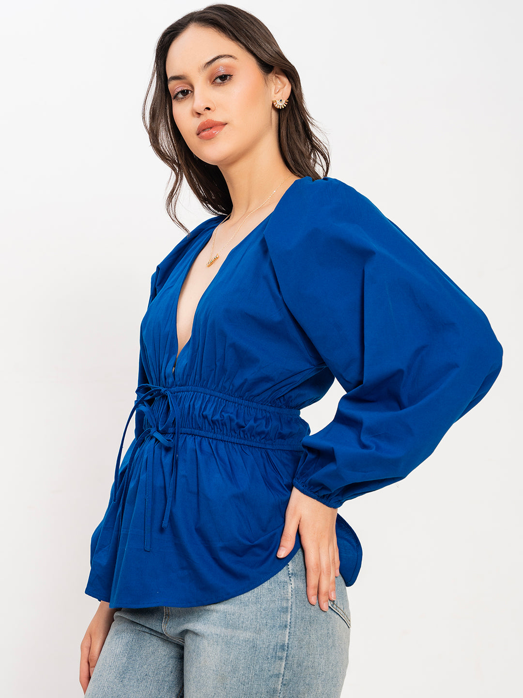 Lifestyle shot of woman wearing blue V-neck top