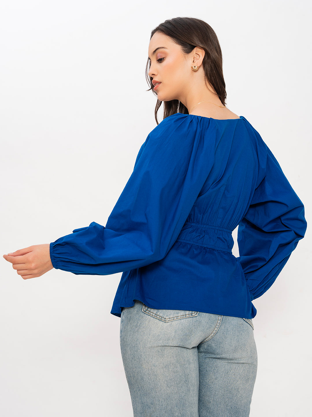 Styling shot of blue V-neck top with denim