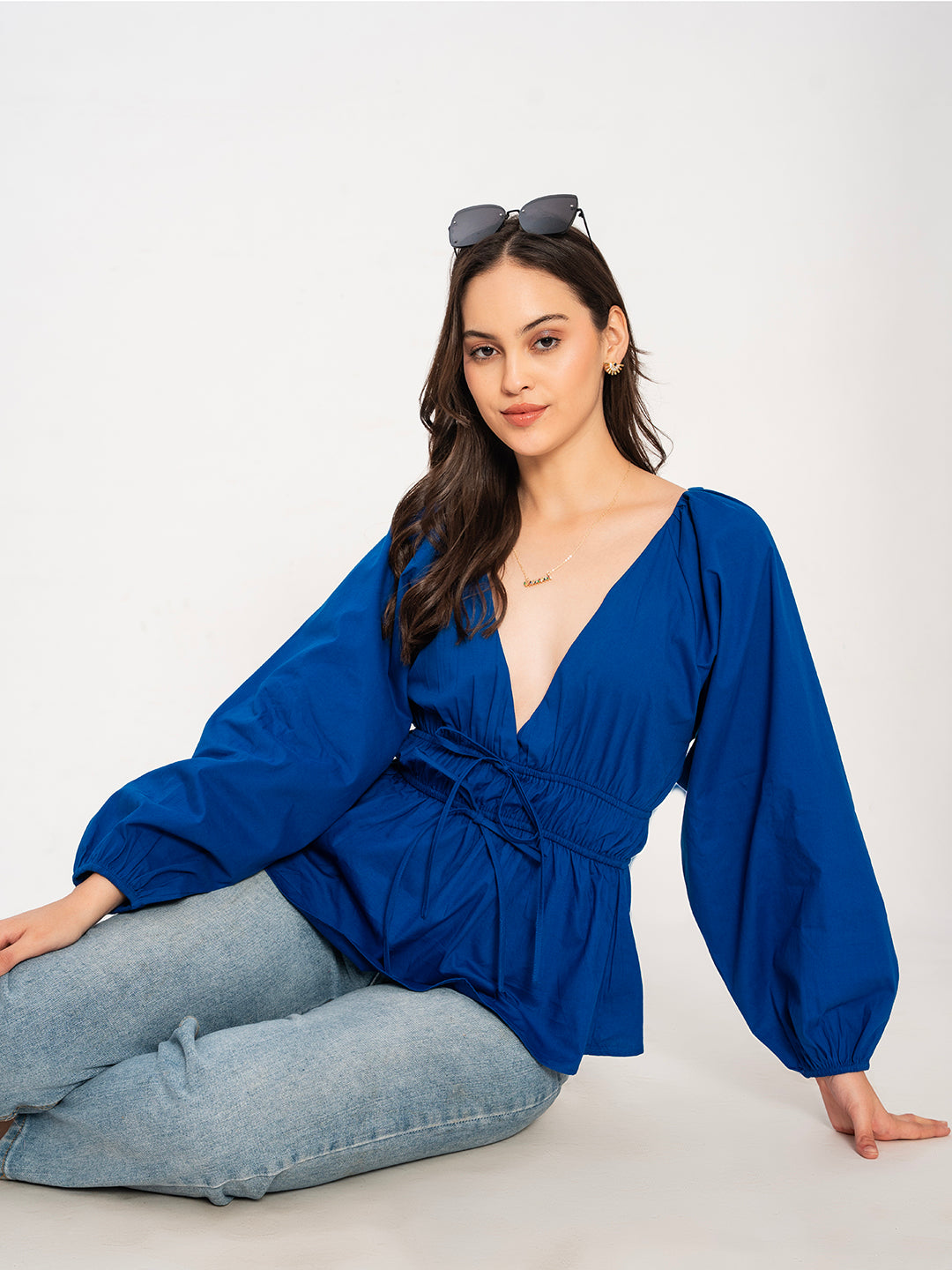 Close-up of V-neckline on blue poplin cotton top