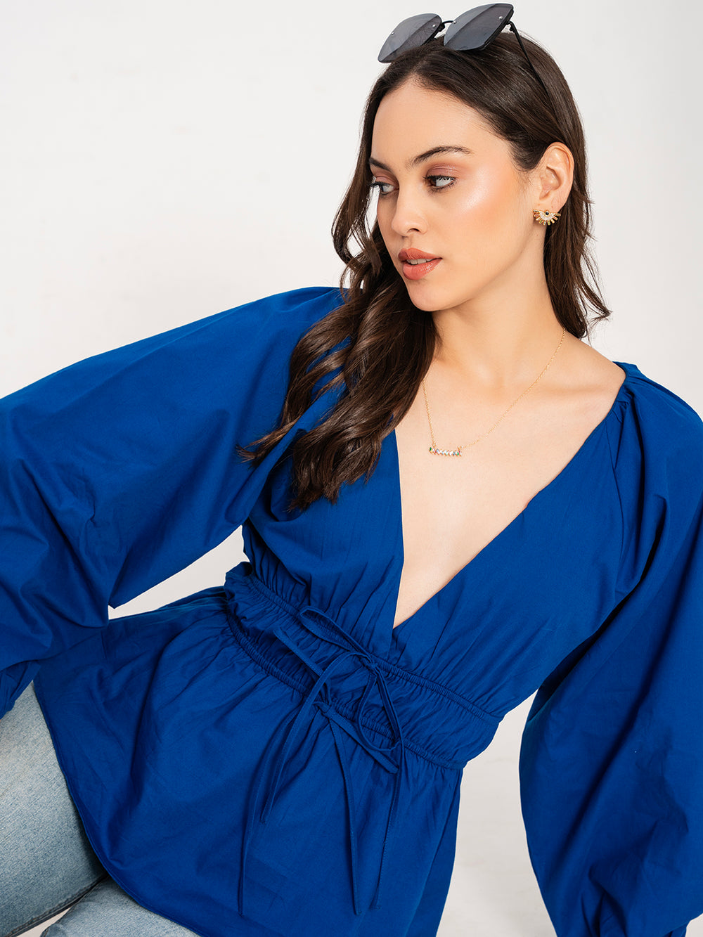 Side view of blue V-neck poplin top