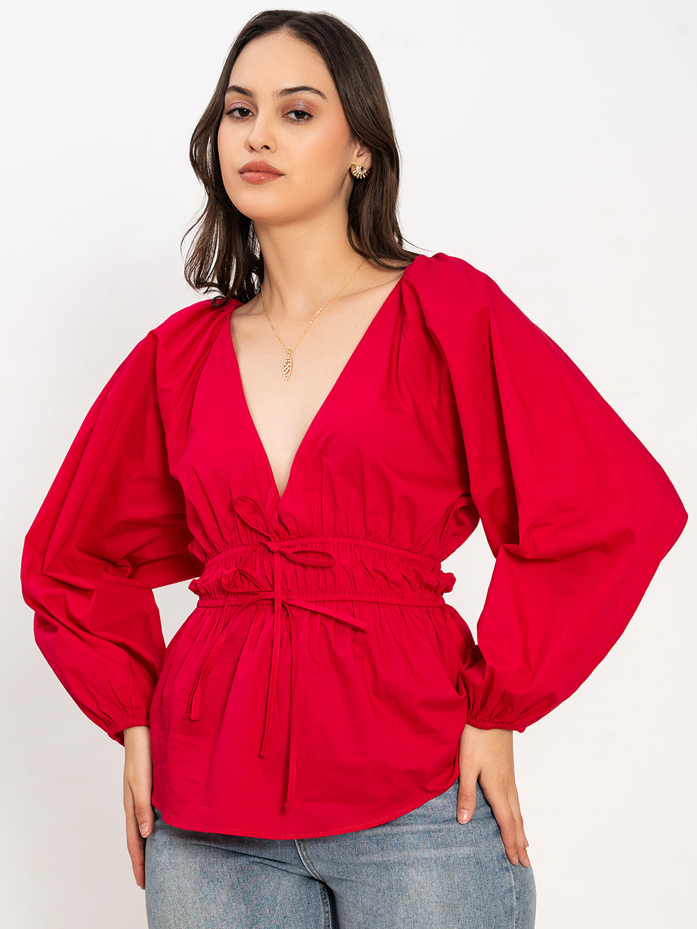 Lifestyle shot of woman wearing pink cotton V-neck top
