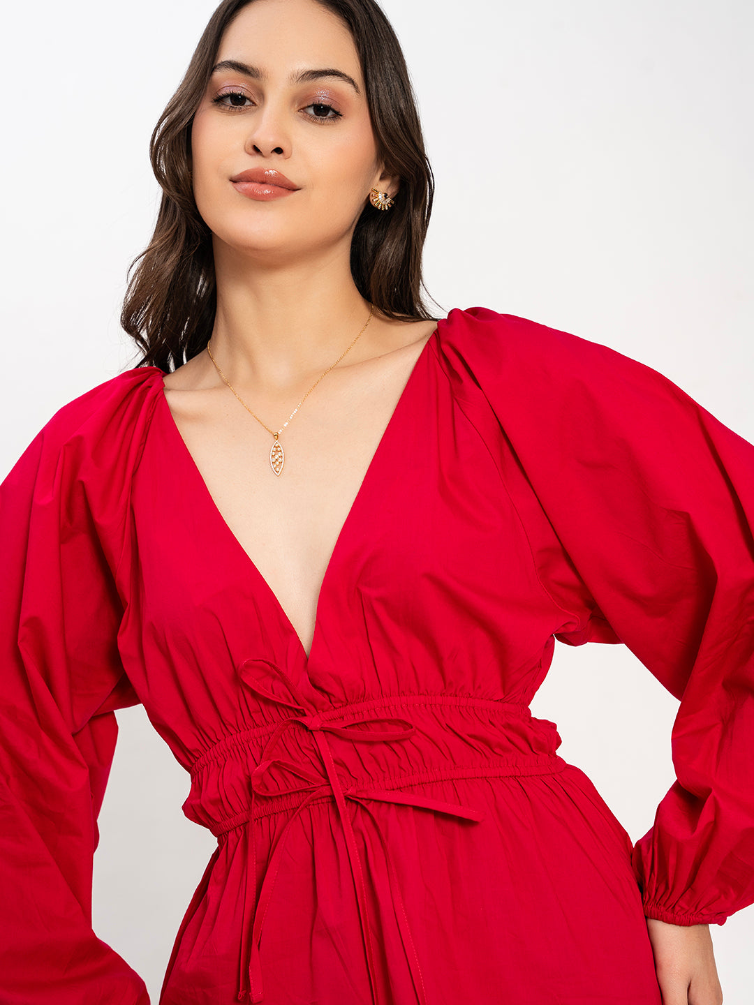 Detail of buttoned cuff on pink poplin top