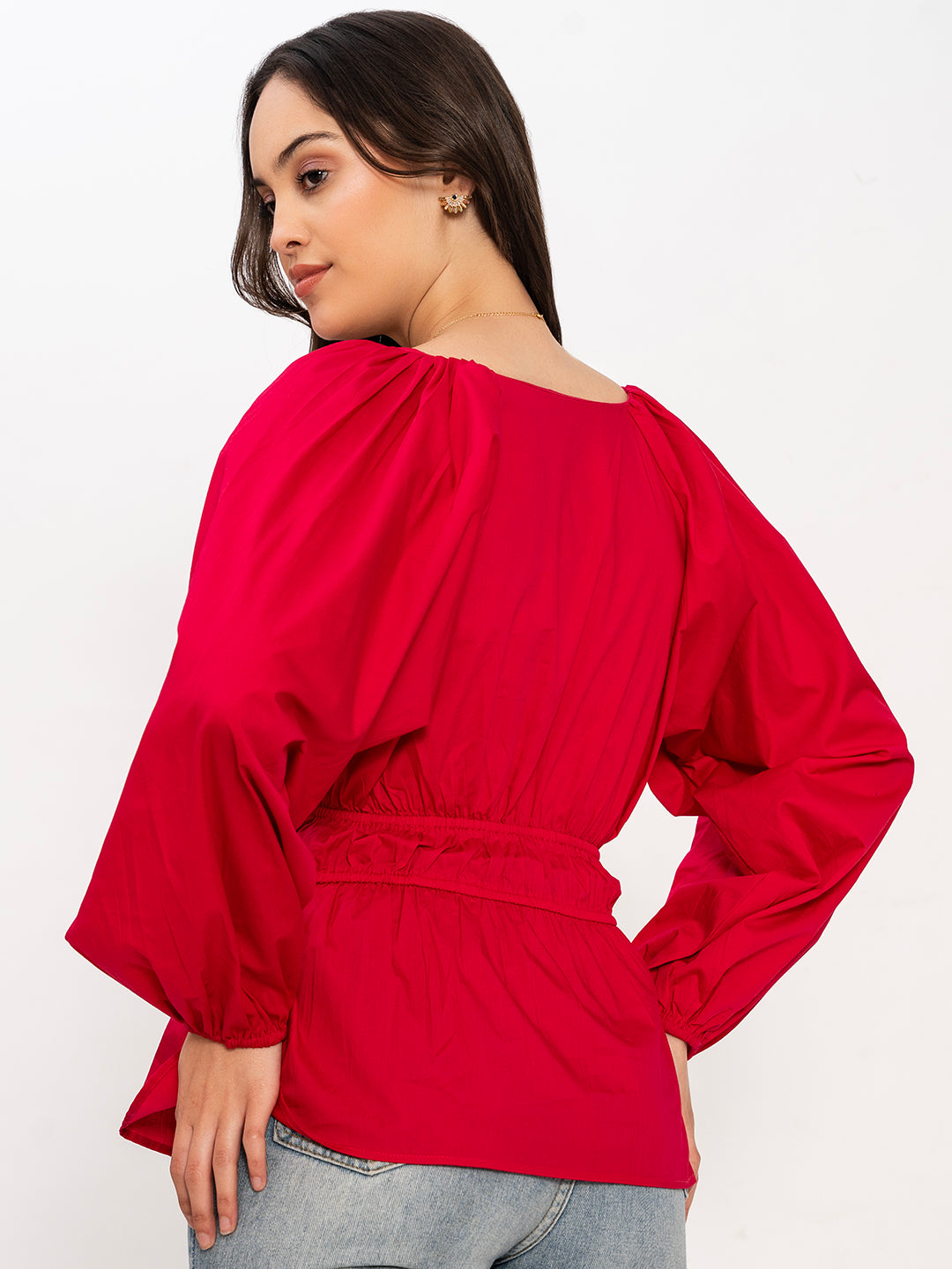 Styled view of pink V-neck top with denim