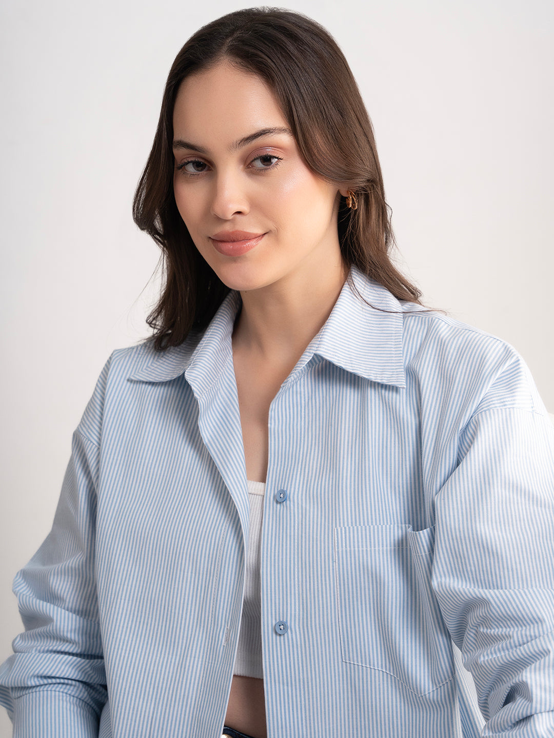 Blue striped cotton shirt with curved hem