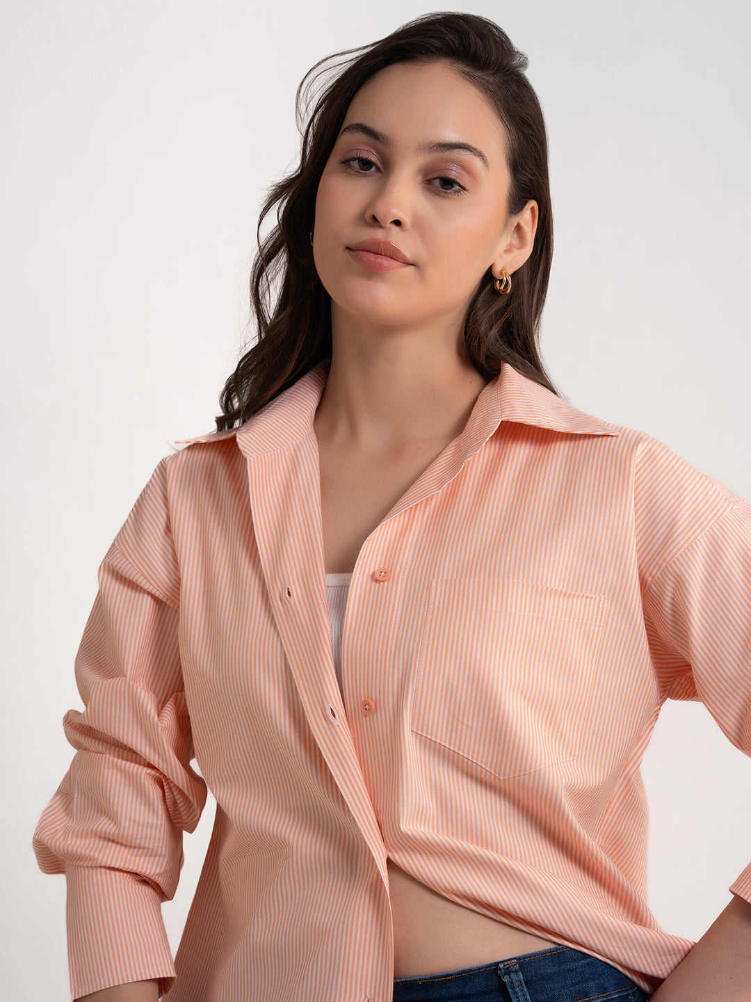 Detail of buttons on orange striped shirt