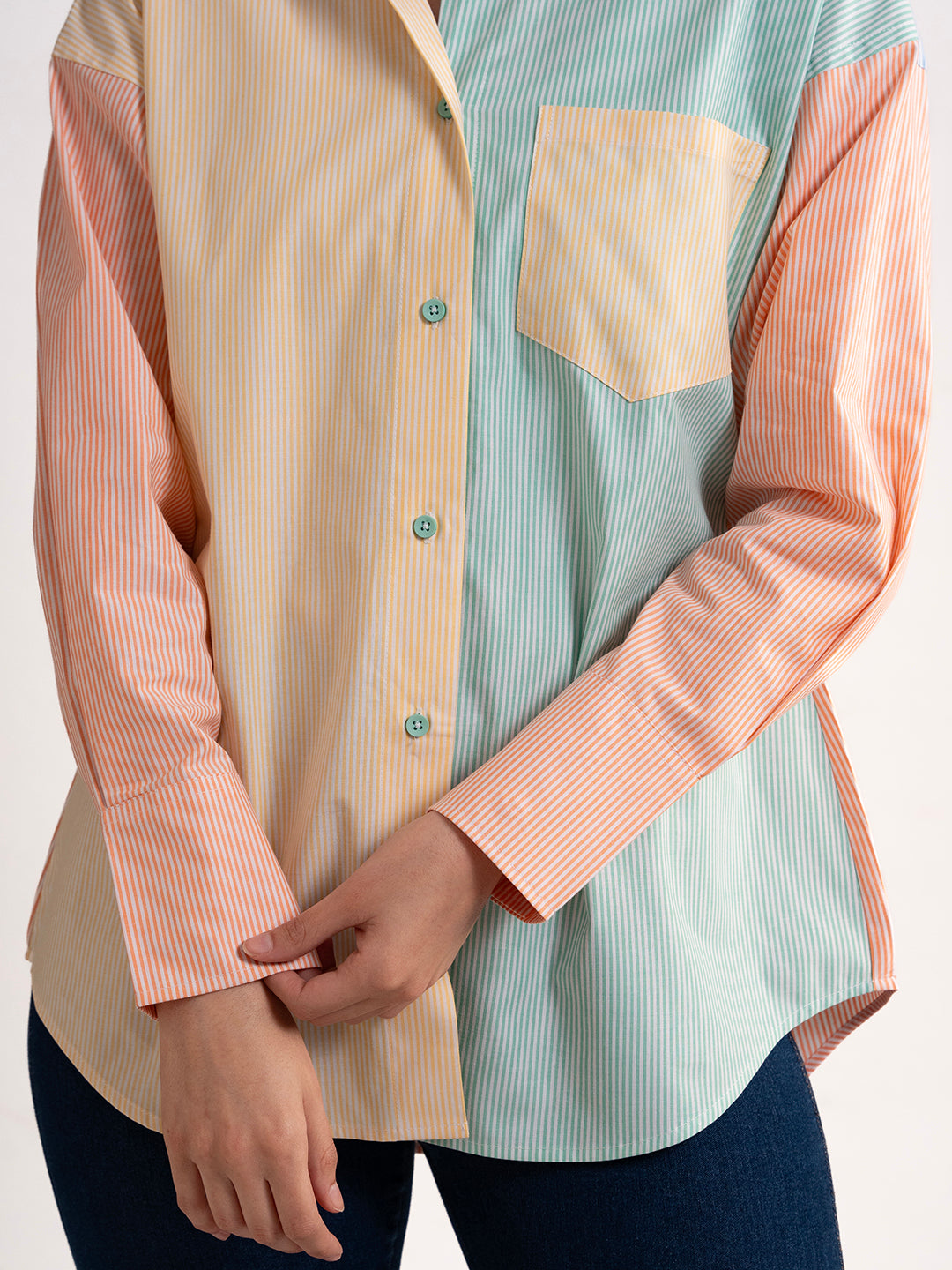 Detail of buttons on colorblocked striped shirt