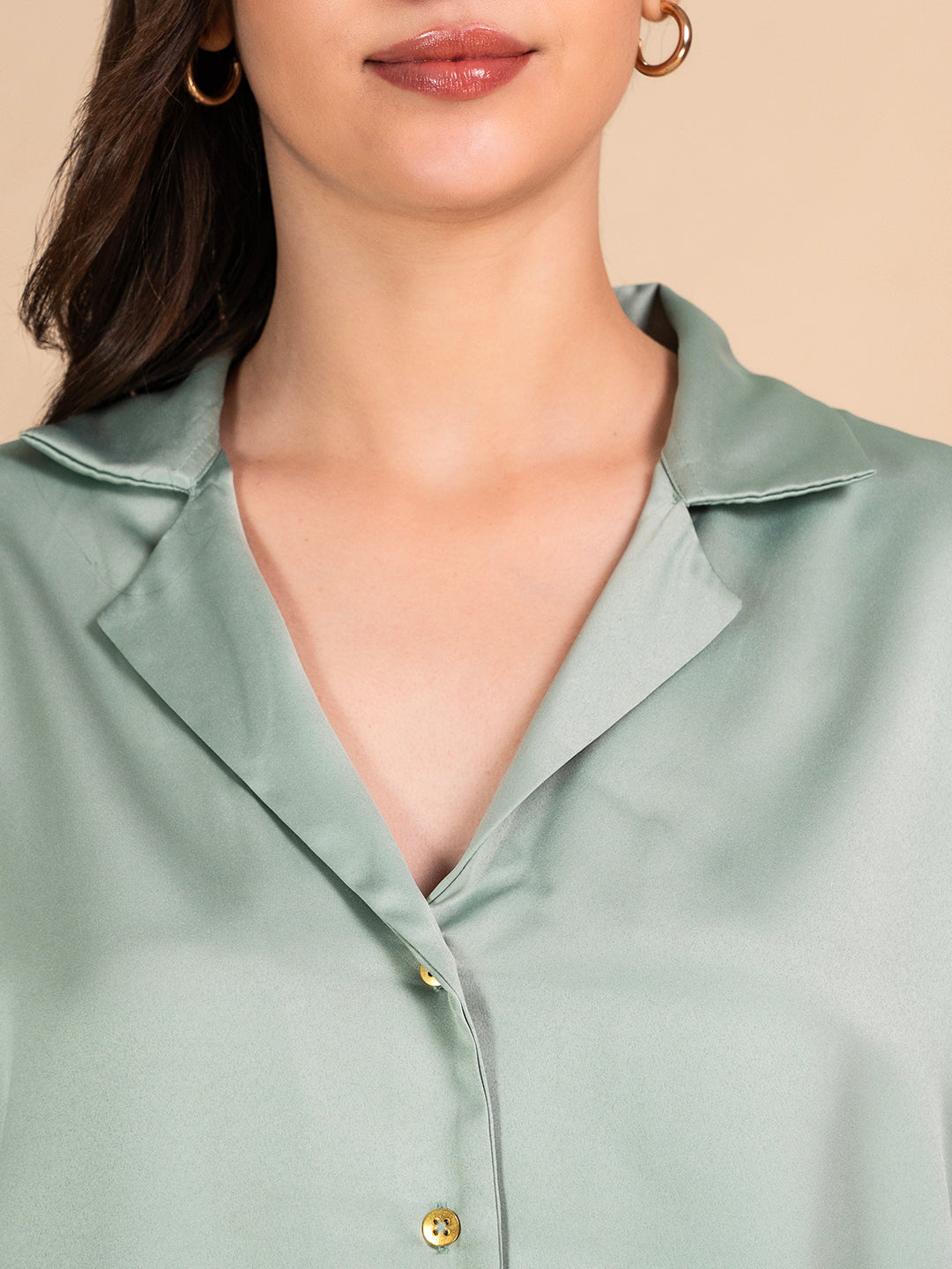 Side view of green satin shirt with relaxed fit