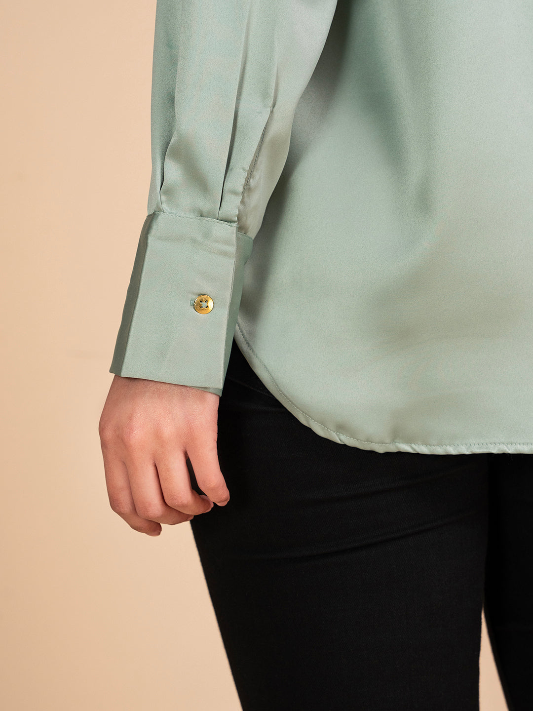 Detail of buttons on green satin shirt