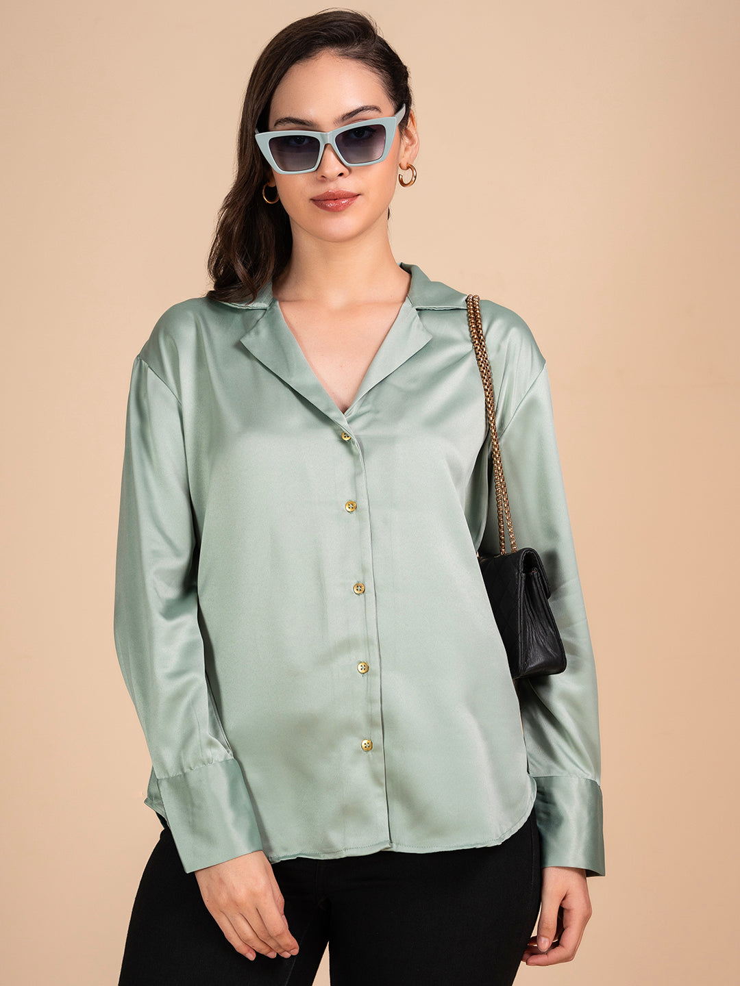 Close-up of green satin fabric and Cuban collar