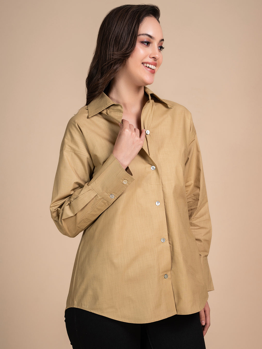 Lifestyle shot of woman wearing beige linen shirt