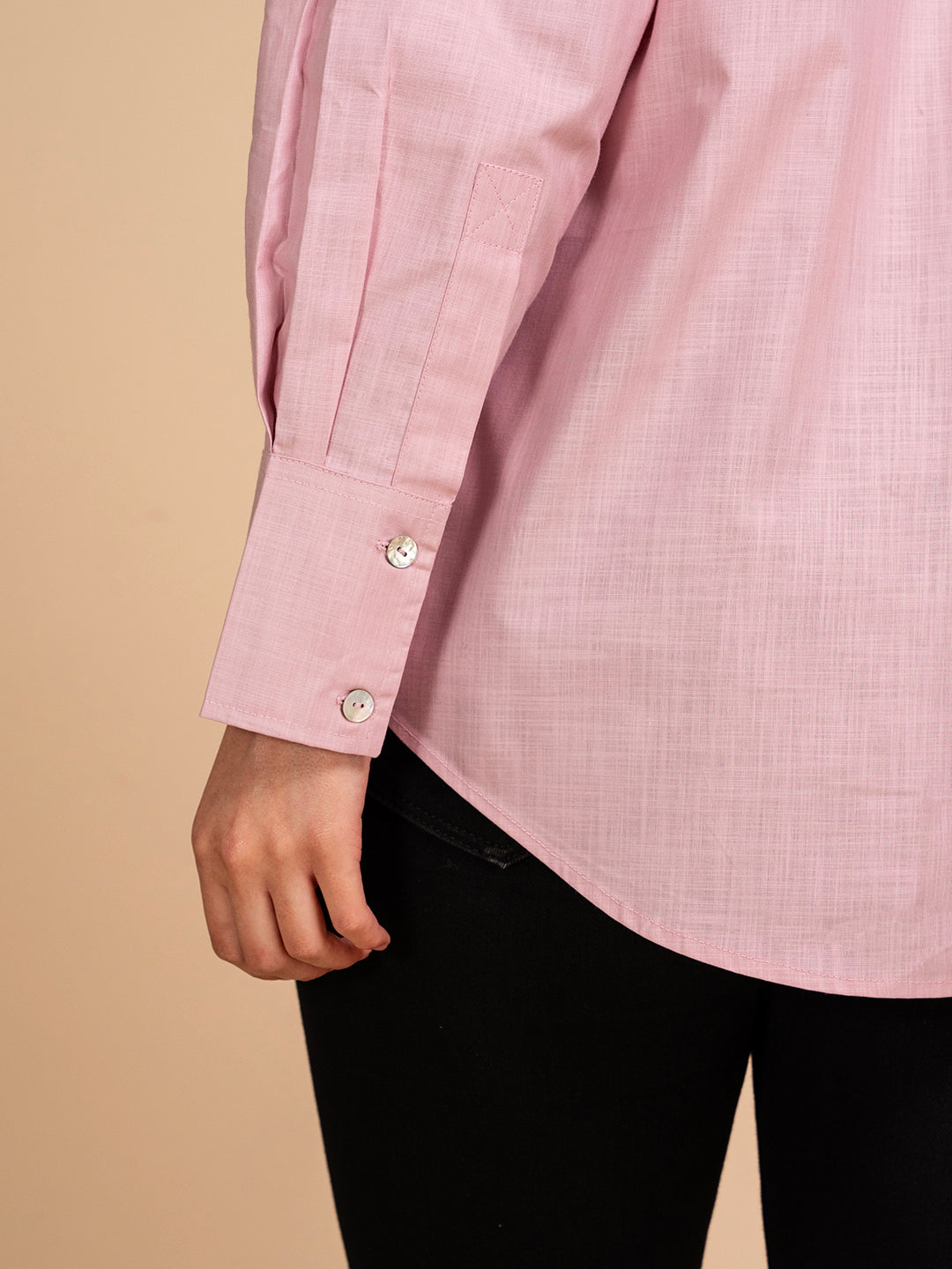 Styled view of pink linen shirt with trousers