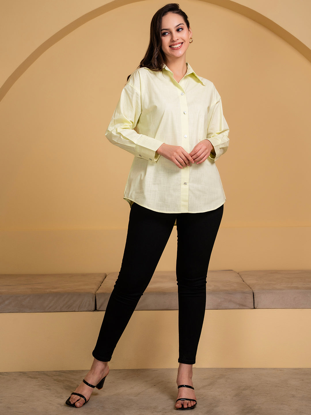 Lifestyle shot of woman wearing green linen shirt