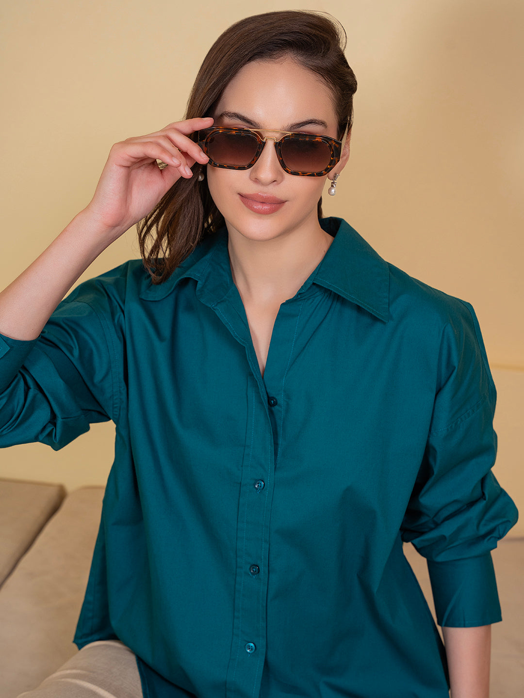 Woman wearing turquoise cotton oversized shirt - front view