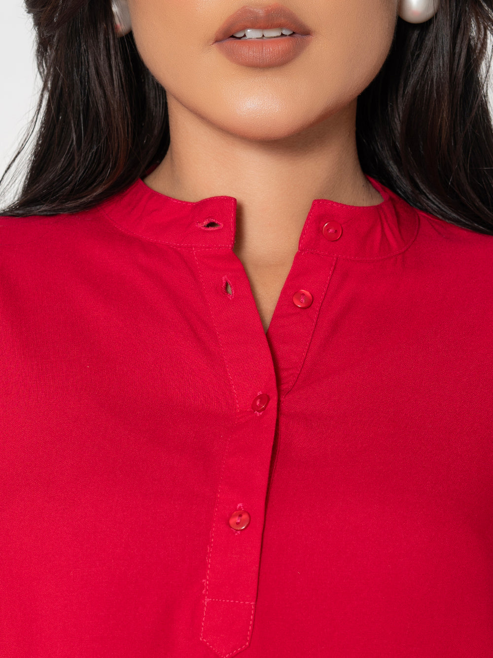 Side view of hot pink rayon top showing fluid drape