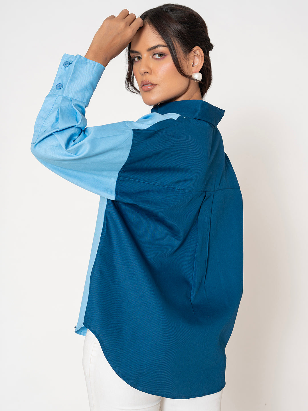 Curved hem and cuff detail of the oversized shirt