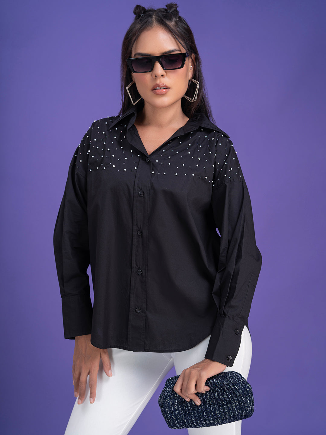 Curved hem and cuff detail on black oversized shirt