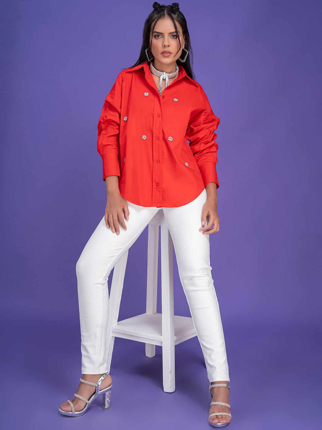 Curved hem and cuff detail on red oversized shirt