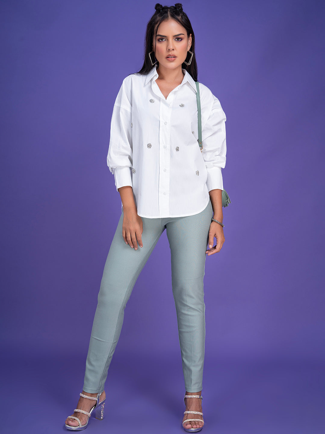Curved hem and cuff detail on white oversized shirt