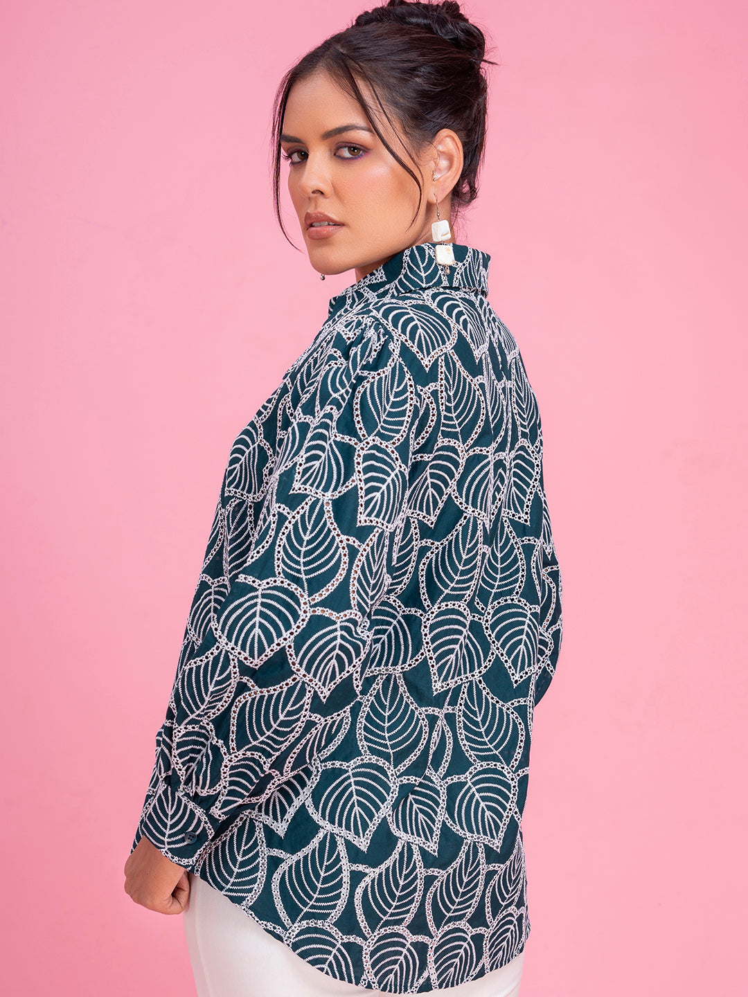 Close-up of schiffli embroidery on green cotton shirt