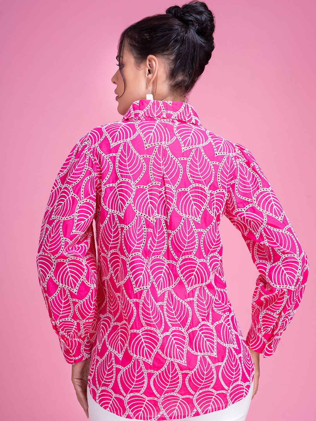 Close-up of schiffli embroidery on pink cotton shirt