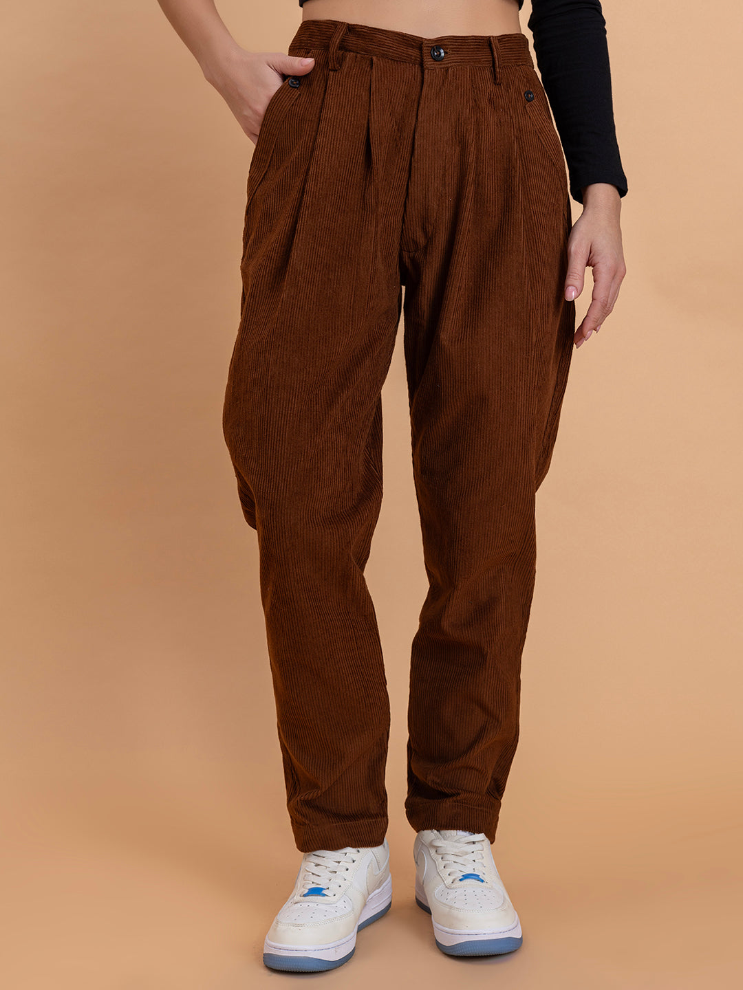 Front view of brown corduroy baggy trousers for women with mid-rise fit
