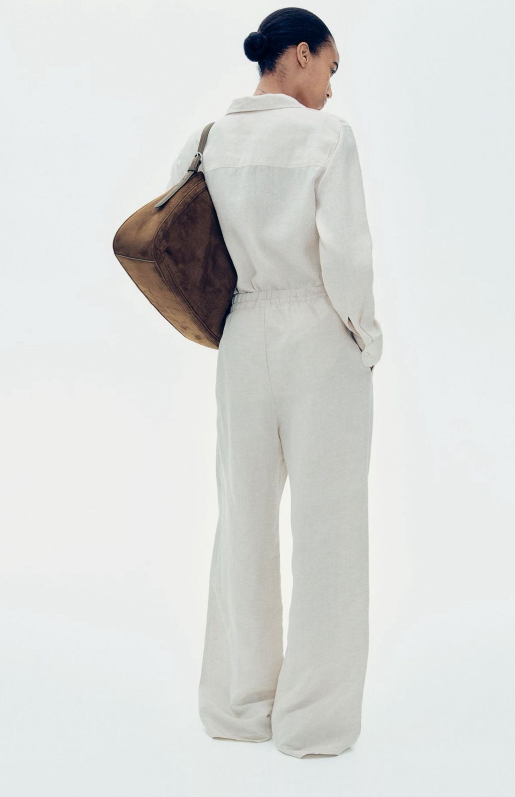 Back view of off-white linen blend baggy trousers
