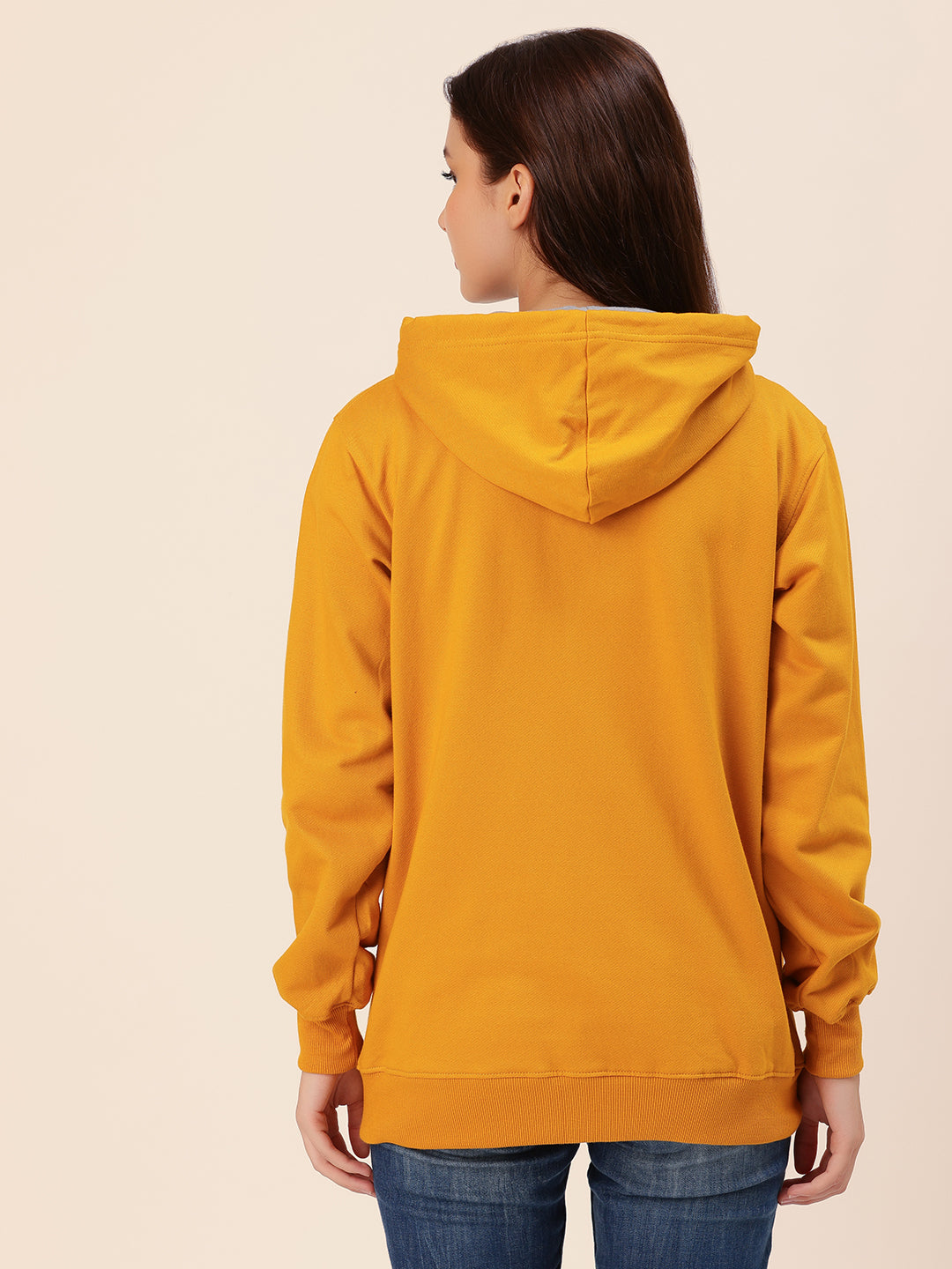 Lifestyle shot of woman wearing mustard cotton fleece hoodie