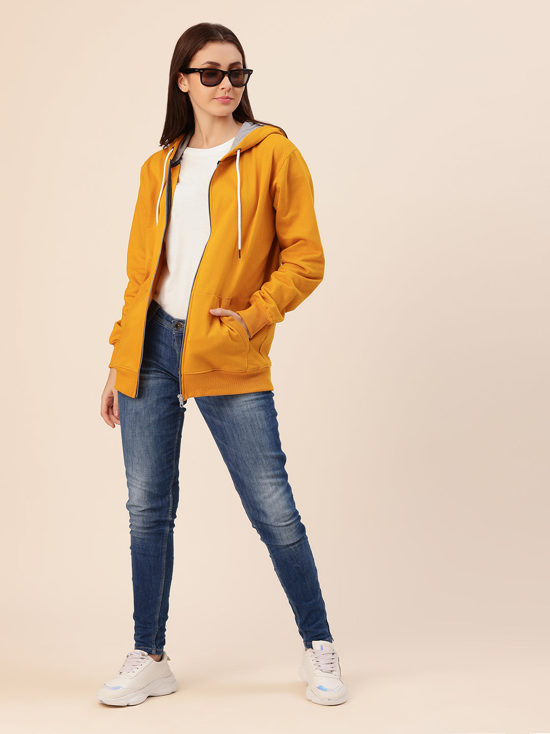 Close-up of hood and ribbed cuffs on mustard hoodie