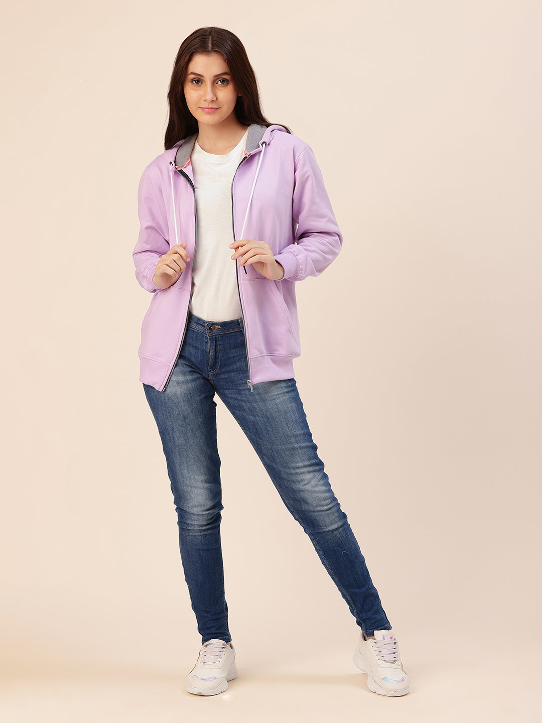 Lifestyle shot of woman wearing lavender cotton fleece hoodie